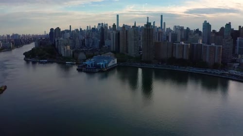 epic aerial camera tilts up to reveal the New York City skyline with a nice reflection in the East R