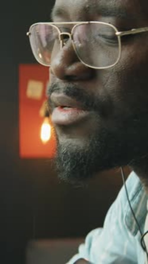 African American Man Performing Guitar Play Within Home Recording studio