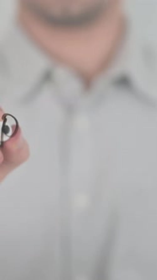 Adult Writes "Pension" on Glass Surface with Marker