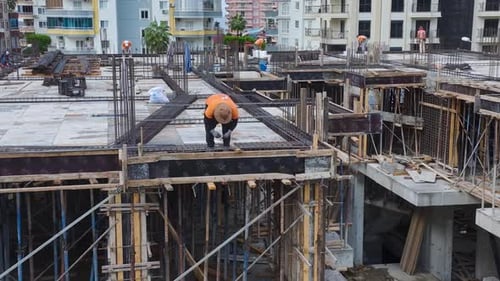 Luftaufnahme: Bauarbeiter biegen Bewehrungsstahl und bereiten sich auf zukünftige Arbeitsphasen vor