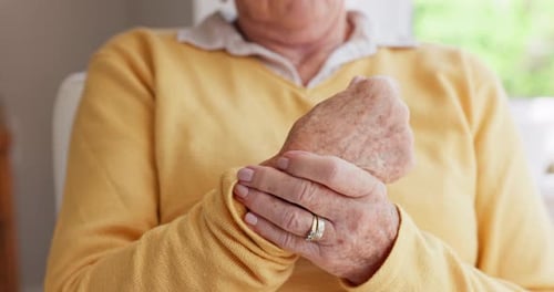 Mature Woman Touches Aching Wrist