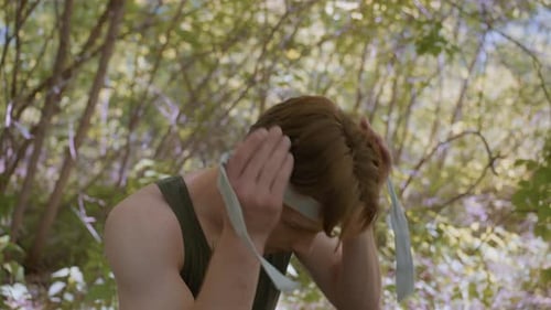 Soldier Tying Headband in Forest Ready for Fight and Action