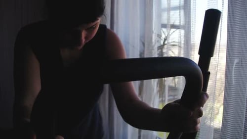 Girl Training on an Elliptical Trainer