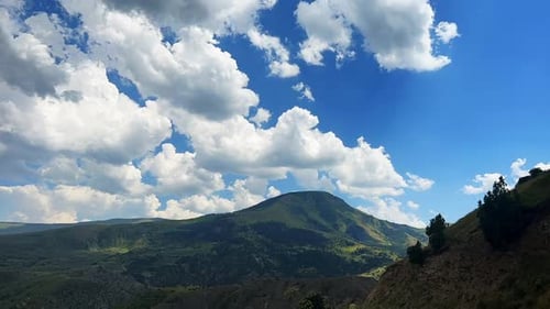 Scenic Mountain Landscape Under a Cloudy Blue Sky