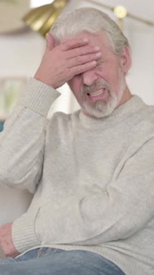 Senior Man Rubbing Temples, Experiencing a Headache