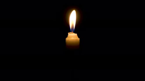 Mysterious subtle candle light in darkness, flame on black background