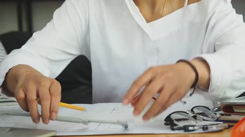 An architect or engineer working on blueprint, architectural concept.