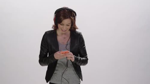 Woman with Headphones Using Mobile Phone