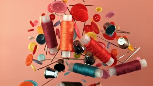 Colorful Sewing Notions Floating on Pink Background