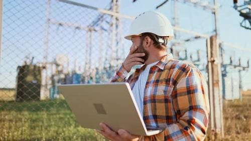 Male Engineer Using Laptop Computer to Online Work in Wheat Field Thinks and Rubs His Beard