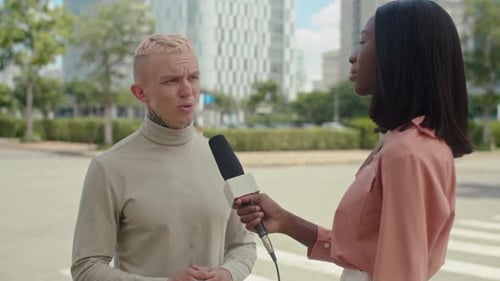 Man Giving Interview to Female Journalist at Street
