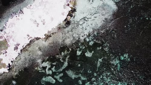 Aerial View of a Vibrant Coral Reef Adjacent to a White Sand Beach Near a Tropical Island