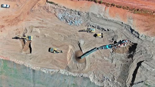 Aerial View Of Heavy Machinery Operating At Busy Construction Site