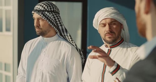 Couple of Corporate Managers Talking to Middle East Businessmen About Agreementmeeting Plan