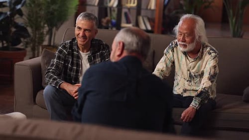 Four Friends Chatting on Couches in a Living Room