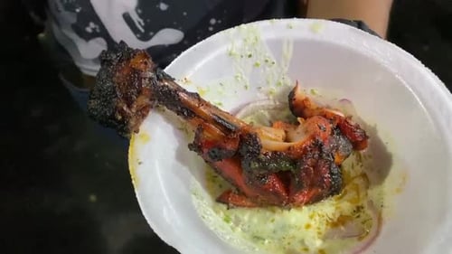 Chicken Tangri kabab or kebab with green chutney in a thermocol plate in outdoor.