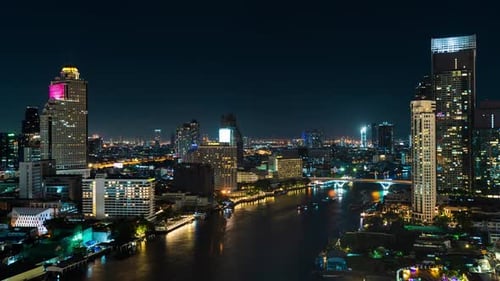 time lapse of Chao Phraya River with King Taksin bridge and building of Bangkok city at night