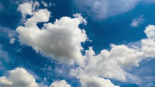 Light white clouds moving along the sky. Low angle view timelapse on sunny day.