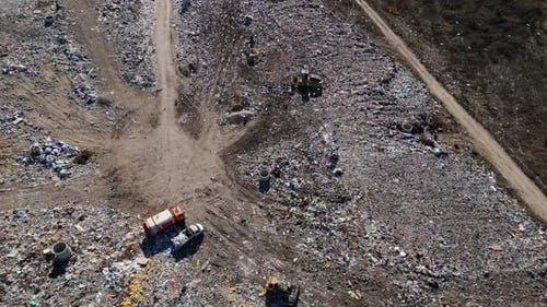 Aerial View of a Vast Landfill Where Bulldozers are Working and Trucks are Bringing New Waste Huge