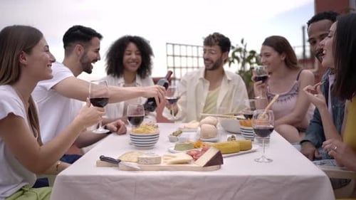 Friends Enjoying Wine and Snacks on Rooftop