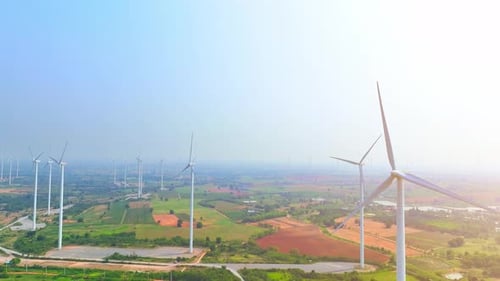Vast wind farm with numerous turbines standing tall, aerial view drone.