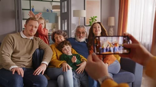 Happy Multi-Generational Family Poses for Photo on Couch