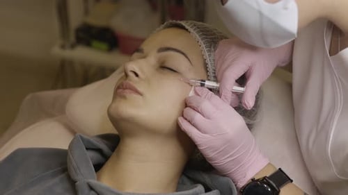 Woman Receiving Facial Injection in Medical Setting