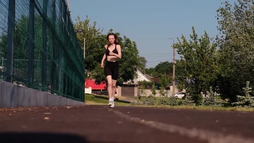 Fitness woman runner. Exercise Runner Cardio Jogging. Fit athlete runner training at sunrise. Joggin