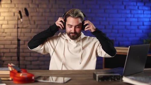 Smiling Musician Wearing Headphones at Recording Studio