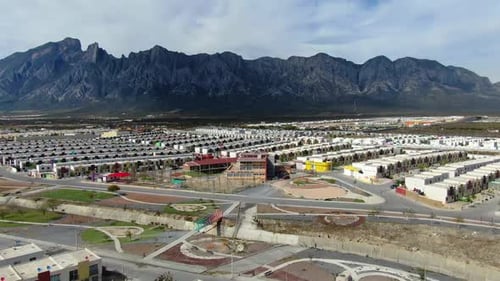 Expansive Residential Development Nestled Beneath Rugged and Majestic Mountain Peaks