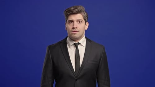 Man in Suit Looking Around Confused