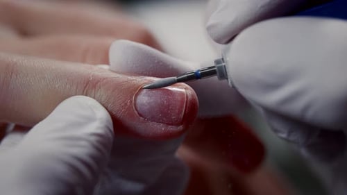 Manicurist Uses an Electric Machine to File the Nails Nail Art Master Prepares Fingers for Polish