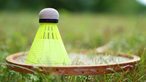 Neongelber Badminton-Federball und Schläger auf grünem Gras im Freien Copy Space Soft Selective Focus