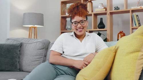 Face, black woman and smile on sofa in living room, lounge and apartment for easy lifestyle