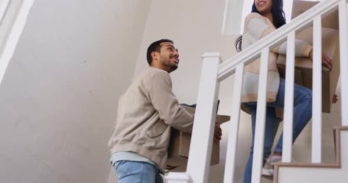 Couple, moving and walking with cardboard, boxes and happy with new house investment in real estate