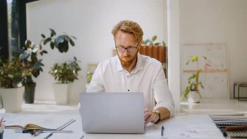 Man Working at Laptop in Bright Modern Office