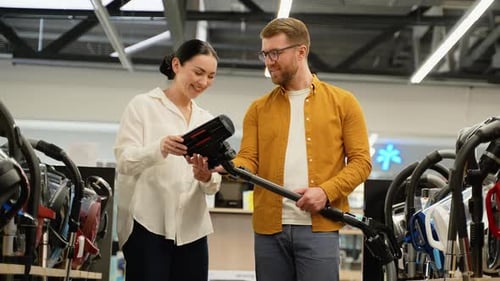 Couple Choosing Vacuum Cleaner in an Electronics Tech Store