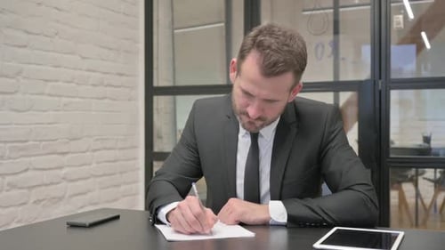 Middle Aged Businessman Writing a Letter