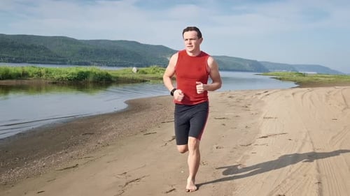 Man Runs on a Beach