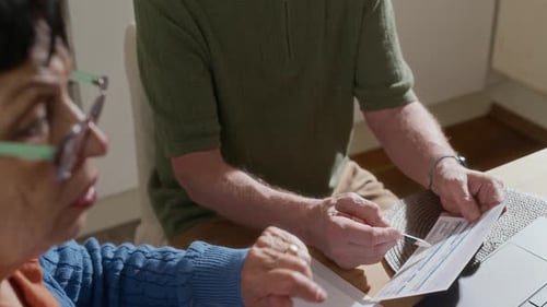 Mature Couple Reviewing Finances at Home Together