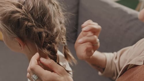 Woman Styling Her Daughters Hair