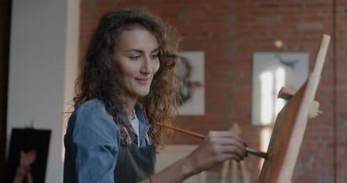 Young Woman Painting in an Art Studio