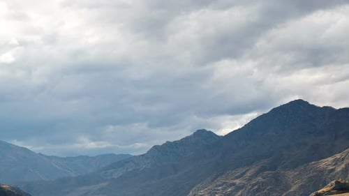 Mountain Range Beneath Dramatic Cloudy Sky Time Lapse