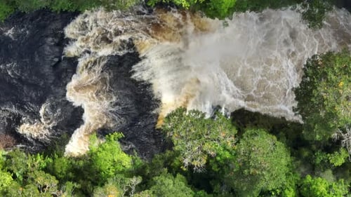 Powerful Waterfall Crashing Through Jungle River