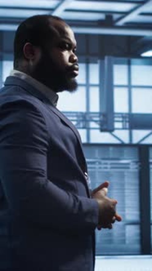 Vertical Video Technician Walking in Data Center Monitoring Systems to Identify Errors