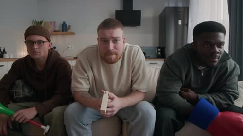 Excited Friends Cheer Together in Living Room