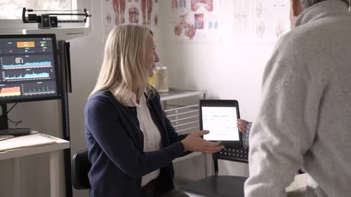 Female Doctor Showing Test Results to Senior Patient