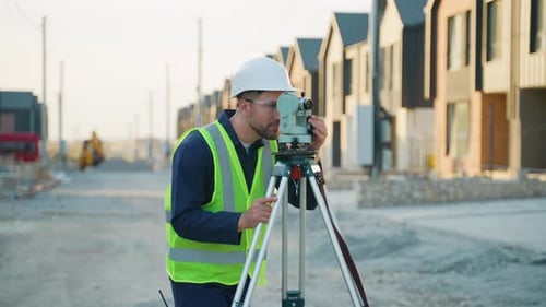 Construction Surveyor Using Theodolite Tool at Building Site