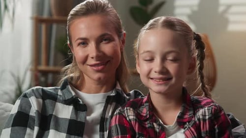 Blonde Haired Woman and Child Smiling Indoors
