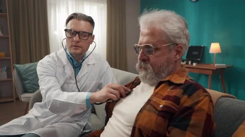 Doctor Listens to Senior Patient at Home